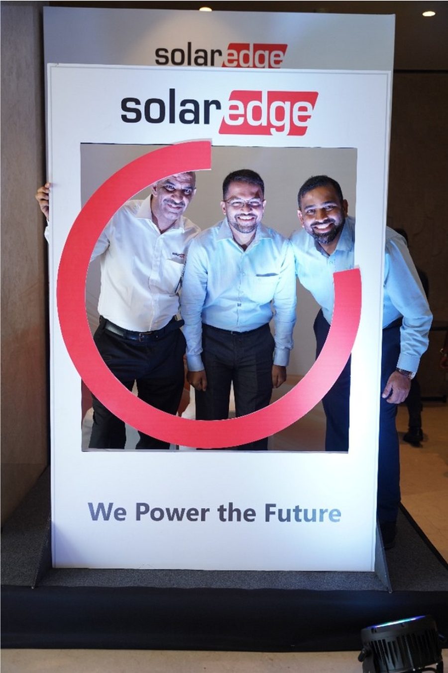 Guests posing at the branded SolarEdge We Power the Future photo booth