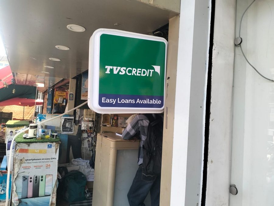 TVS Credit Easy Loans Available door decal at a retail store