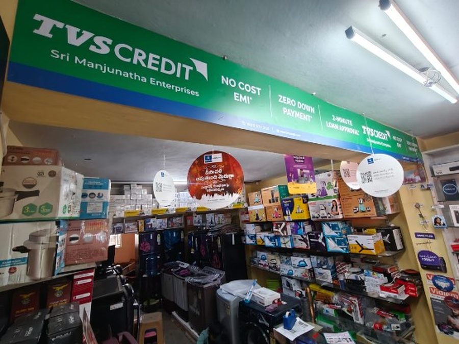 TVS Credit branded signage above Sri Manjunatha Enterprises electronics store